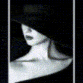 a black and white portrait of a woman wearing a hat