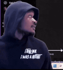 a man wearing a hooded shirt that says i told her i was a referee