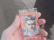 a person is holding a package of show cards with a picture of elvis presley