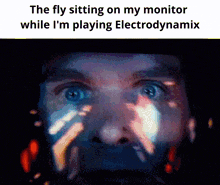 a close up of a man 's face with the words the fly sitting on my monitor