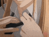 a close up of a person adjusting their shirt and tie