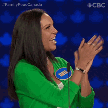 a woman wearing a green sweater with a name tag that says tanny