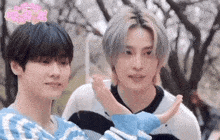 two young men are standing next to each other and one of them is giving the other a high five