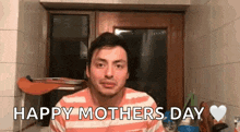 a man in a striped shirt is saying happy mother 's day in a bathroom .