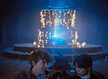 a man and a woman are standing in front of a fountain that says " i love you " on it