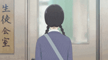 a girl is standing in front of a sign that says ' classroom ' on it