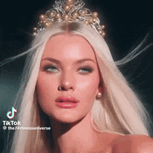 a woman with long blonde hair wearing a tiara and earrings