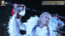 a woman in a white feathered costume is holding a dragon head