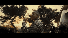 a man in a zebra print shirt is standing in front of a house