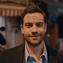 a man in a suit has a message written on his forehead