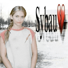 a woman stands in front of a sybau sign