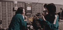a group of people are sitting in a room with a striped wall