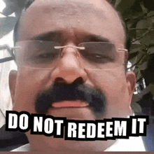 a man with glasses and a mustache has the words do not redeem it above his face