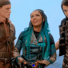 a woman with blue hair is standing next to a man