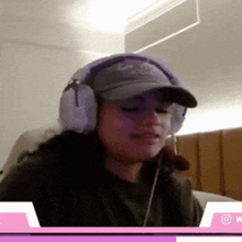a woman wearing headphones and a hat that says ' abercrombie & fitch ' on it