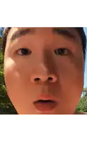 a close up of a man 's face with a surprised expression