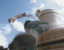 a man wearing a white shirt and a mask is walking
