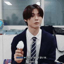 a man in a suit and tie is holding an ice cream cone with the word hong on it