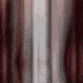 a blurred image of a red and white curtain with the word daskv visible