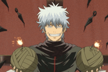 a man with a bandage on his arm is smiling in front of knives