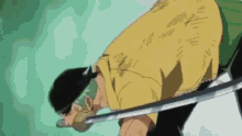 a man in a yellow shirt is holding a sword in his right hand .