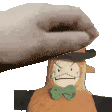 a hand is putting a hat on a stuffed animal with an angry face .