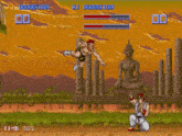 a video game with two fighters and a buddha statue