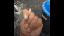 a close up of a person 's hand making a heart shape with their fingers