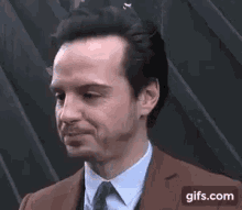 a close up of a man in a suit and tie .