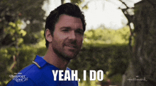 a man in a blue shirt says yeah i do in white letters