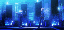 a group of people are standing on a stage in front of a city at night