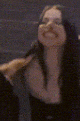 a blurry photo of a woman covering her face with her hands .