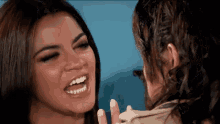 two women are looking at each other and one is smiling