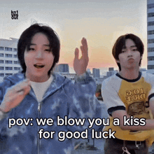 two young men are standing next to each other and one of them says " pov : we blow you a kiss for good luck " ..