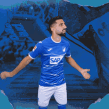 a man is wearing a blue shirt with the word sap on it