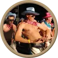 a group of men in cowboy hats and bandanas are dancing in a circle