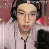 a man wearing glasses and headphones with t98 strong written on the bottom right