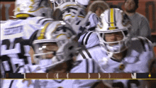 a group of football players are huddled together and one of them has the number 21 on his shirt