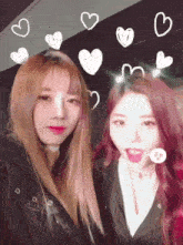 two girls are posing for a picture with hearts drawn on their faces