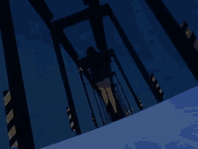 a woman in a pink skirt is walking across a blue bridge