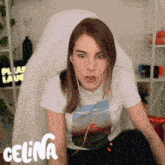 a woman wearing headphones is sitting in a chair with the word celina on the bottom