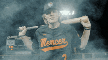 a baseball player for the mercer team holding a bat
