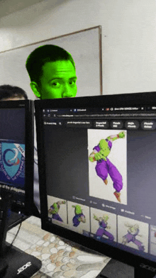 a man with a green face is looking at an acer computer