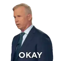 a man in a suit and tie has the word okay on his shirt