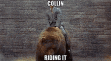a man in a suit is riding a brown bear with the words collin riding it on the bottom