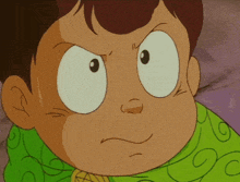 a close up of a cartoon character 's face with a green shirt