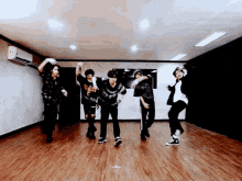 a group of young men are dancing in a dark room