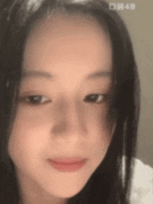 a close up of a young girl 's face with long hair .