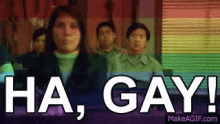 a group of people are standing in front of a rainbow flag and a sign that says ha gay