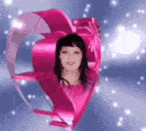 a girl in a pink heart with a bow around her head